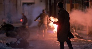 Movie still from “Streets of Fire” (1984), directed by Walter Hill – A group of people riding motorcycles on a street at night; Wide shot, Over the shoulder angle