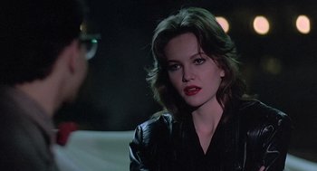 Movie still from “Streets of Fire” (1984), directed by Walter Hill – A woman in a black leather jacket looking at the camera; Close Up shot, Over the shoulder angle