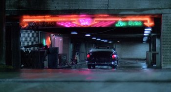 Movie still from “Streets of Fire” (1984), directed by Walter Hill – A car parked in a parking garage at night; Wide shot, Low angle