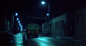 Movie still from “Streets of Fire” (1984), directed by Walter Hill – A yellow bus driving down a street at night; Extreme Wide shot, Low angle