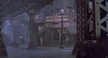 Movie still from “Streets of Fire” (1984), directed by Walter Hill – An image of a street scene in the fog; Extreme Wide shot, High angle