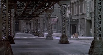 Movie still from “Streets of Fire” (1984), directed by Walter Hill – An empty city street with a lot of street lights; Extreme Wide shot, High angle