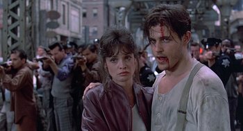 Movie still from “Streets of Fire” (1984), directed by Walter Hill – A man and a woman with blood all over their faces; Close Up shot, Low angle