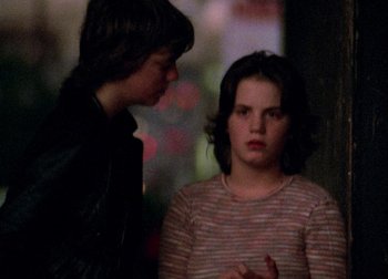 Two young people standing next to each other
