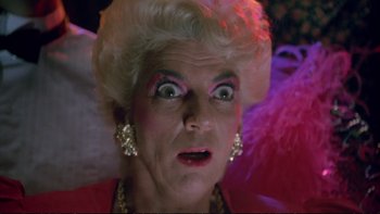 Movie still from “Strictly Ballroom” (1992), directed by Baz Luhrmann – An older woman with a surprised look on her face; Close Up shot, Low angle