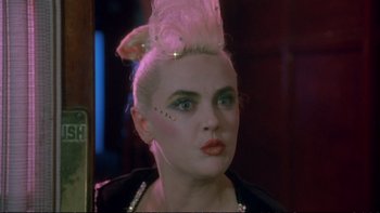 Movie still from “Strictly Ballroom” (1992), directed by Baz Luhrmann – A woman with white hair is looking into a mirror; Close Up shot, Low angle