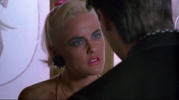 Movie still from “Strictly Ballroom” (1992), directed by Baz Luhrmann – A woman looking at a man in the mirror; Close Up shot, Over the shoulder angle
