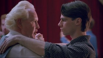 Movie still from “Strictly Ballroom” (1992), directed by Baz Luhrmann – A man and a woman are touching each other; Close Up shot, Low angle