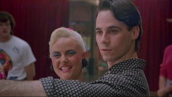 Movie still from “Strictly Ballroom” (1992), directed by Baz Luhrmann – A man and a woman pose for a picture; Close Up shot, Low angle