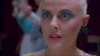 Movie still from “Strictly Ballroom” (1992), directed by Baz Luhrmann – A person with green eyes; Close Up shot, Low angle