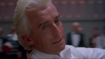 Movie still from “Strictly Ballroom” (1992), directed by Baz Luhrmann – A man with white hair and a white bow tie; Close Up shot, Low angle