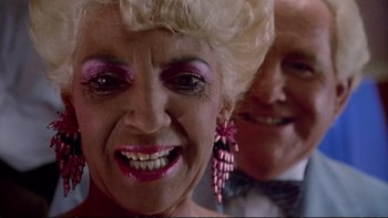 Movie still from “Strictly Ballroom” (1992), directed by Baz Luhrmann – An older woman with pink lipstick and a bow in her hair; Close Up shot, Low angle
