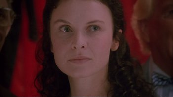 Movie still from “Strictly Ballroom” (1992), directed by Baz Luhrmann – A person with long hair and green eyes; Close Up shot, Low angle