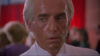 Movie still from “Strictly Ballroom” (1992), directed by Baz Luhrmann – An older man with white hair and a white shirt; Close Up shot, Low angle
