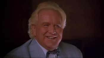 Movie still from “Strictly Ballroom” (1992), directed by Baz Luhrmann – An older man wearing a suit and a bow tie; Close Up shot, Low angle