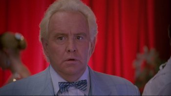Movie still from “Strictly Ballroom” (1992), directed by Baz Luhrmann – An older man in a suit and bow tie looking surprised; Close Up shot, Low angle