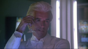 Movie still from “Strictly Ballroom” (1992), directed by Baz Luhrmann – A man in a white suit holding a wine glass in his hand; Close Up shot, Low angle