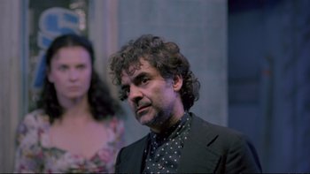 Movie still from “Strictly Ballroom” (1992), directed by Baz Luhrmann – A man in a black suit and a woman in a blue dress; Medium shot, Over the shoulder angle