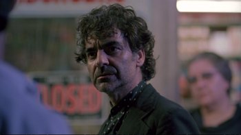 Movie still from “Strictly Ballroom” (1992), directed by Baz Luhrmann – A person wearing a suit and tie; Close Up shot, Low angle