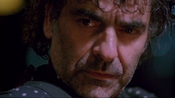 Movie still from “Strictly Ballroom” (1992), directed by Baz Luhrmann – A man's face with a frowning look; Close Up shot, Low angle