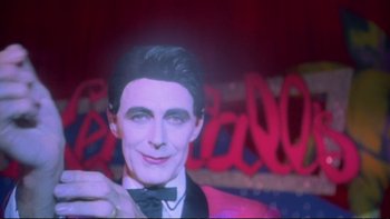 Movie still from “Strictly Ballroom” (1992), directed by Baz Luhrmann – A wax statue of a man in a suit and bow tie; Close Up shot, Low angle