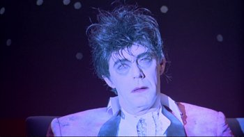 Movie still from “Strictly Ballroom” (1992), directed by Baz Luhrmann – A person wearing a suit and tie; Close Up shot, Low angle