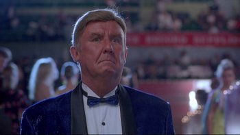 Movie still from “Strictly Ballroom” (1992), directed by Baz Luhrmann – An older man in a suit and bow tie; Close Up shot, Low angle