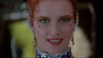 Movie still from “Strictly Ballroom” (1992), directed by Baz Luhrmann – A person with red hair and green eyes; Close Up shot, Low angle