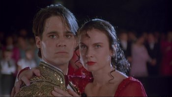 Movie still from “Strictly Ballroom” (1992), directed by Baz Luhrmann – A man and a woman standing next to each other; Close Up shot, Low angle