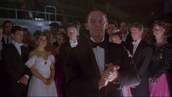 Movie still from “Strictly Ballroom” (1992), directed by Baz Luhrmann – A group of people in formal attire clapping; Medium shot, Low angle