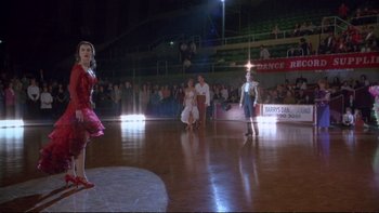 Movie still from “Strictly Ballroom” (1992), directed by Baz Luhrmann – A group of people standing on a dance floor; Wide shot, Low angle