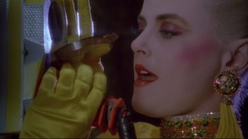 Movie still from “Strictly Ballroom” (1992), directed by Baz Luhrmann – A woman's face with a glass in her hand; Close Up shot, Low angle