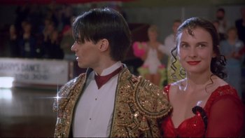 Movie still from “Strictly Ballroom” (1992), directed by Baz Luhrmann – A man and a woman standing next to each other; Close Up shot, Low angle