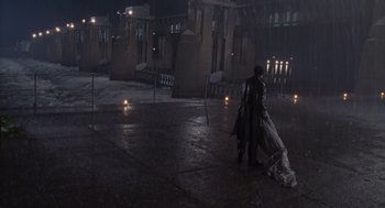 Movie still from “Striking Distance” (1993), directed by Rowdy Herrington – A man in a black jacket and a white dress; Extreme Wide shot, High angle