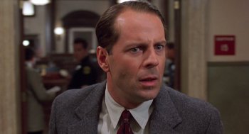 Movie still from “Striking Distance” (1993), directed by Rowdy Herrington – A person wearing a suit and tie; Close Up shot, Low angle