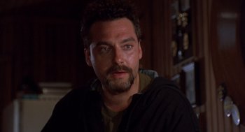 Movie still from “Striking Distance” (1993), directed by Rowdy Herrington – A person with a beard; Close Up shot, Low angle