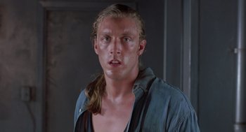 Movie still from “Striking Distance” (1993), directed by Rowdy Herrington – A person with long blonde hair; Close Up shot, Low angle