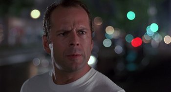 Movie still from “Striking Distance” (1993), directed by Rowdy Herrington – A person wearing a white t - shirt; Close Up shot, Low angle