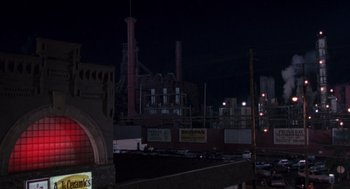 Movie still from “Striking Distance” (1993), directed by Rowdy Herrington – A large industrial area at night with a lot of lights; Extreme Wide shot, High angle