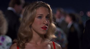 Movie still from “Striking Distance” (1993), directed by Rowdy Herrington – A person wearing a red dress; Close Up shot, Over the shoulder angle