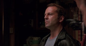 Movie still from “Striking Distance” (1993), directed by Rowdy Herrington – A person wearing a leather jacket; Close Up shot, Low angle