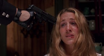 Movie still from “Striking Distance” (1993), directed by Rowdy Herrington – A woman is holding a gun up to her head; Close Up shot, High angle