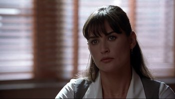 Movie still from “Striptease” (1996), directed by Andrew Bergman – A person wearing a white shirt; Close Up shot, Over the shoulder angle