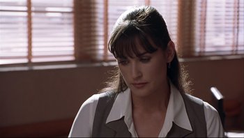 Movie still from “Striptease” (1996), directed by Andrew Bergman – A person wearing a jacket; Close Up shot, Over the shoulder angle