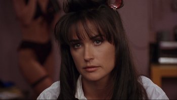 Movie still from “Striptease” (1996), directed by Andrew Bergman – A person with long black hair; Close Up shot, Over the shoulder angle