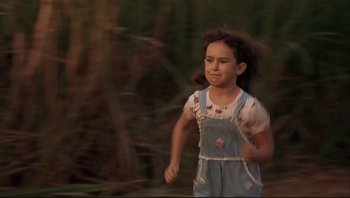 Movie still from “Striptease” (1996), directed by Andrew Bergman – A little girl is running in the woods; Close Up shot, High angle