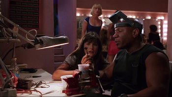 Movie still from “Striptease” (1996), directed by Andrew Bergman – A man and a woman sitting at a dinner table; Close Up shot, Low angle