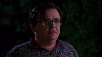 Movie still from “Striptease” (1996), directed by Andrew Bergman – A person wearing glasses; Close Up shot, Low angle