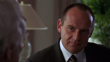 Movie still from “Striptease” (1996), directed by Andrew Bergman – A person wearing a suit and tie; Close Up shot, Over the shoulder angle