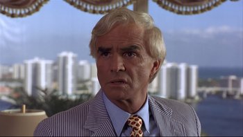 Movie still from “Striptease” (1996), directed by Andrew Bergman – An older man in a suit and tie; Close Up shot, Low angle